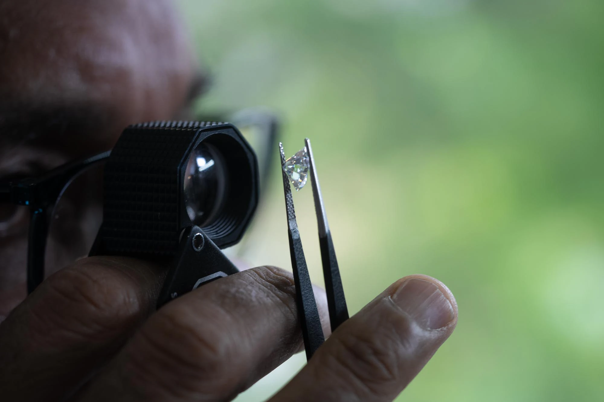 jeweler examining a diamond