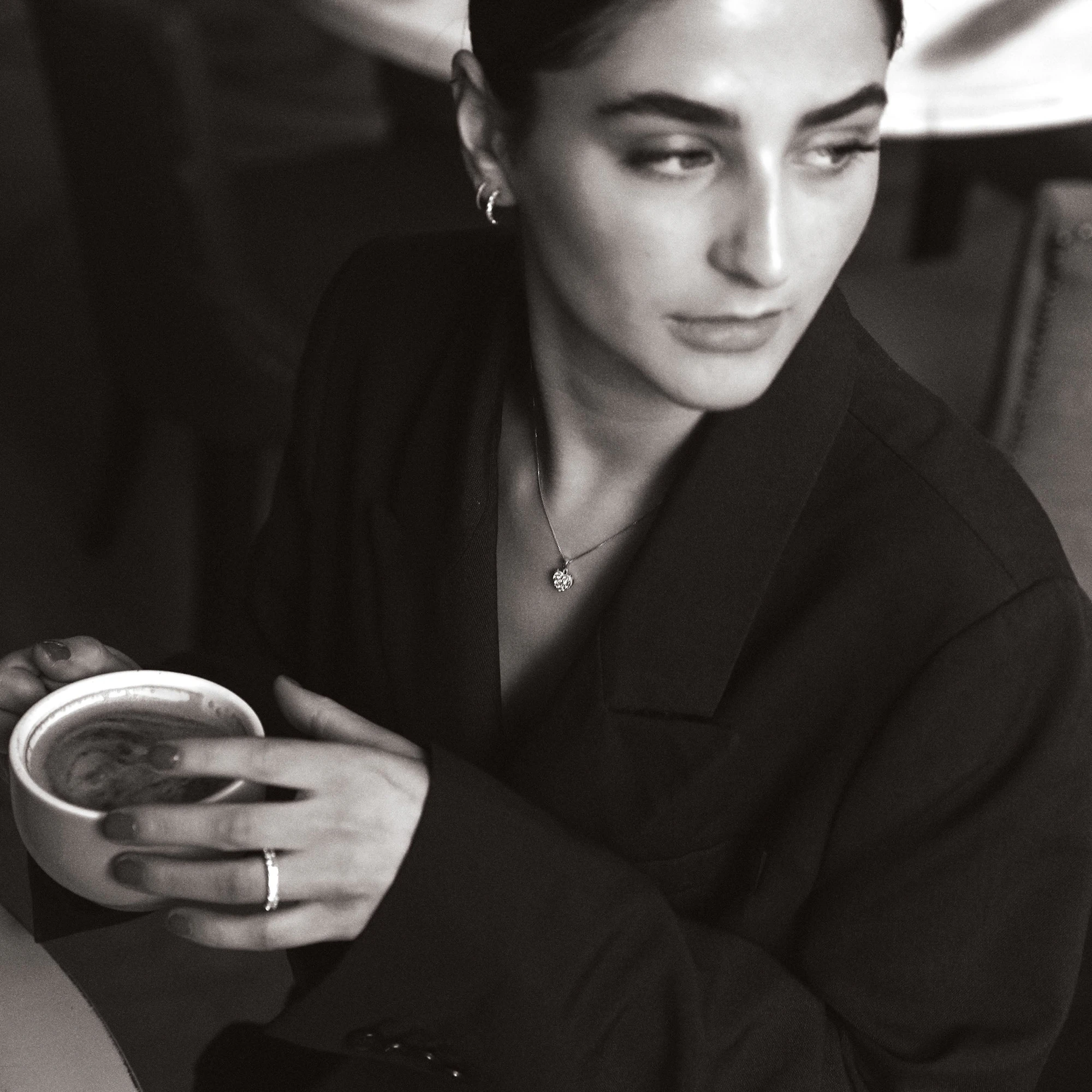 woman in caffe wearing diamond jewellery