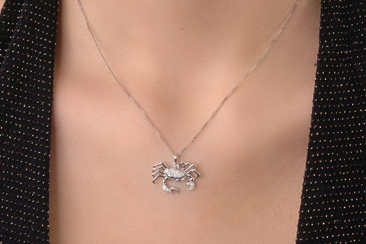 Woman wearing cancer zodiac star sign necklace