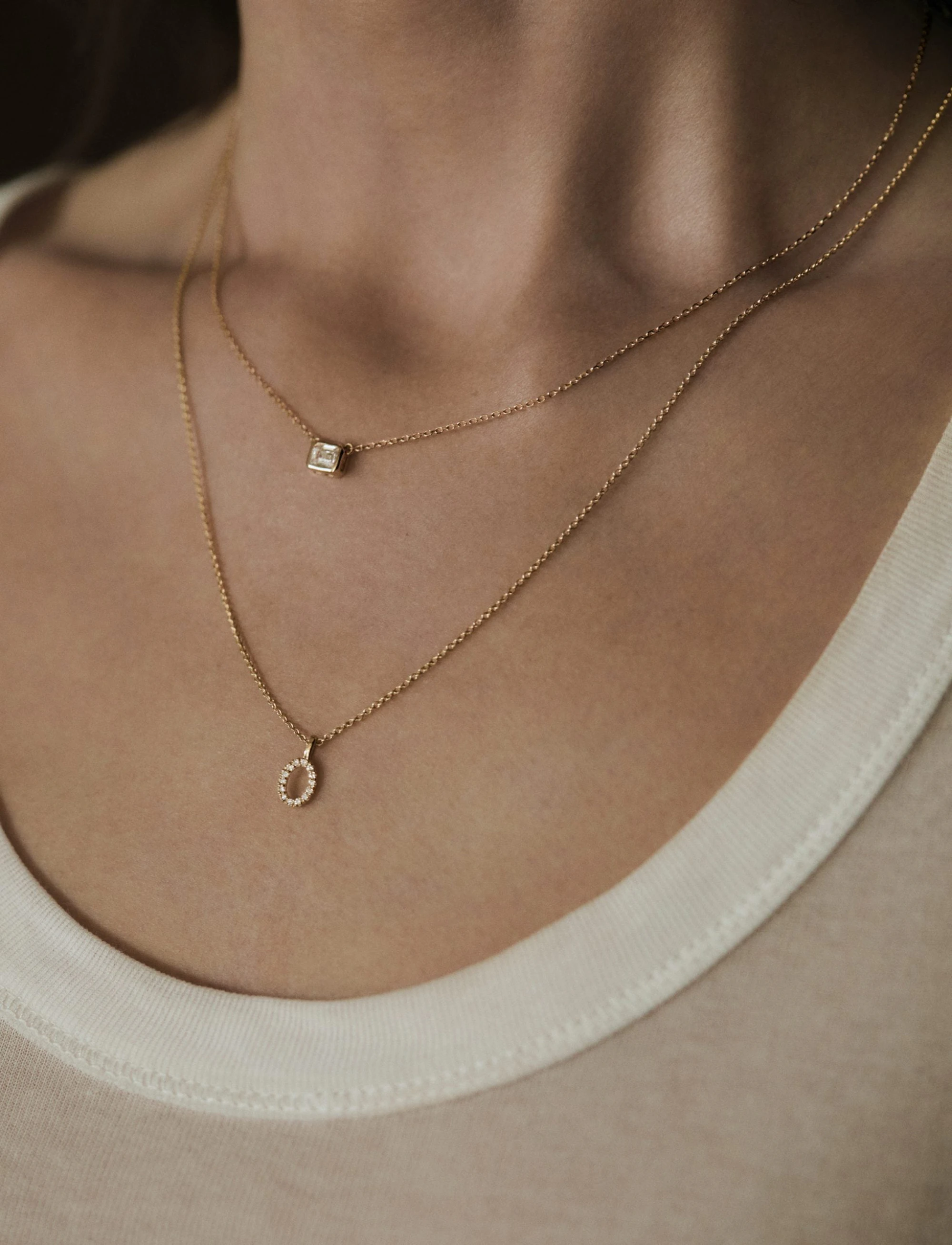woman wearing layered necklaces