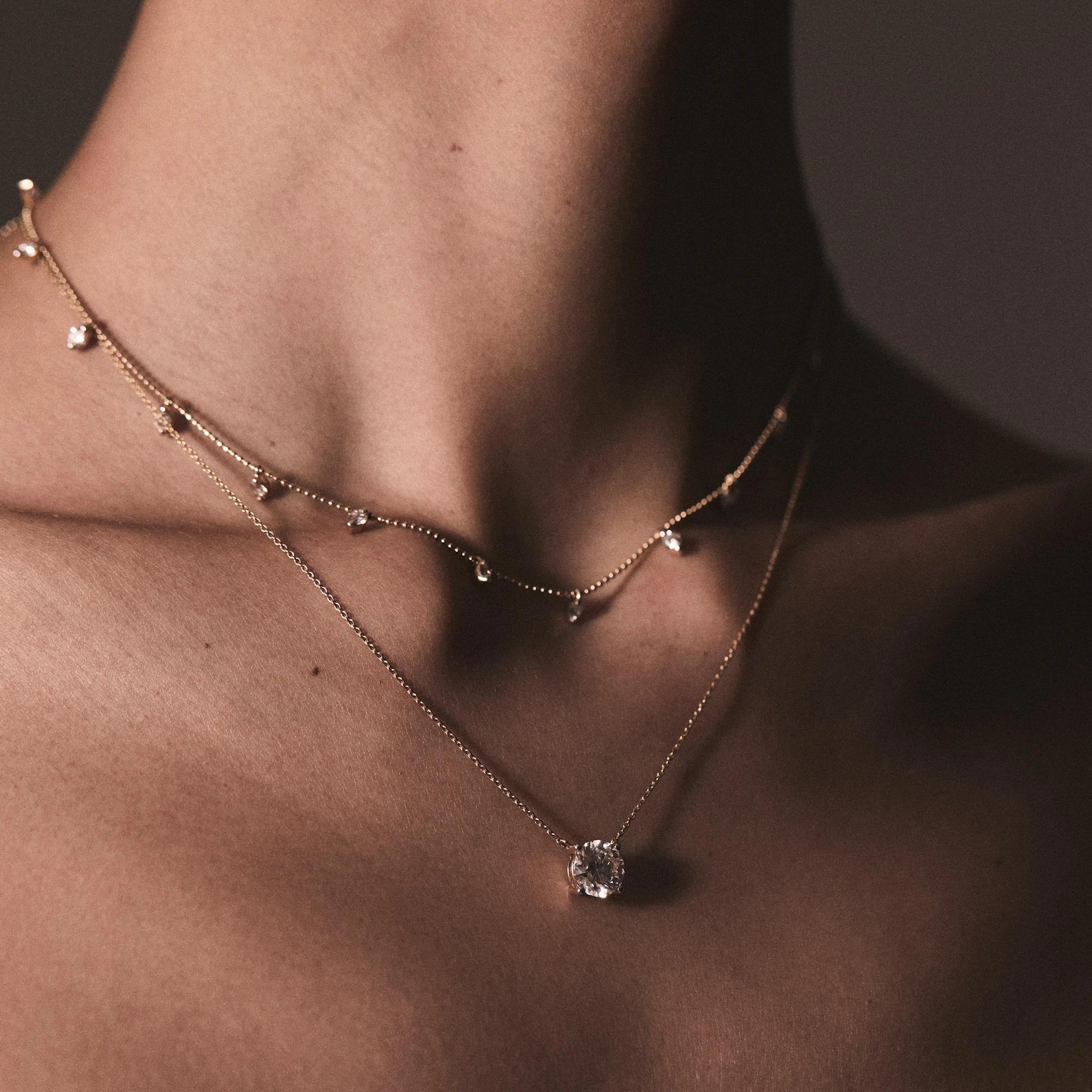 woman wearing stacked necklaces