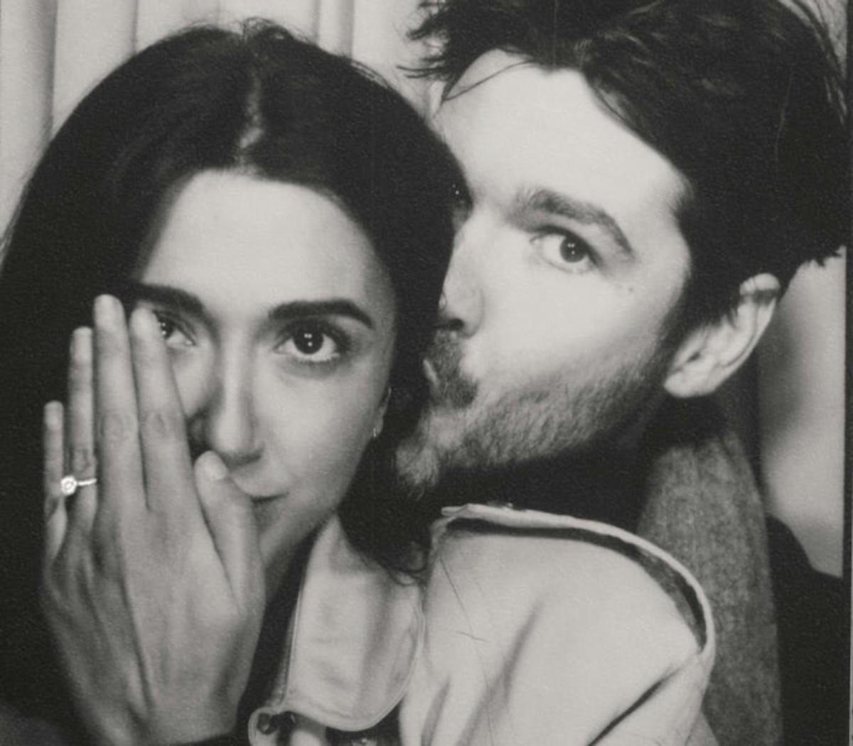 Couple showing engagement ring