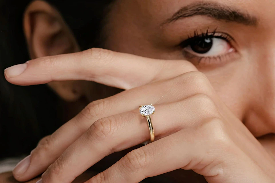 woman with an oval cut diamond ring