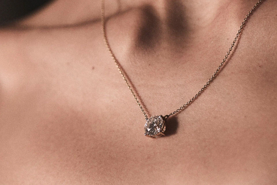 woman wearing diamond pendant