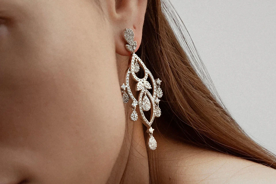 woman wearing chandelier diamond earrings