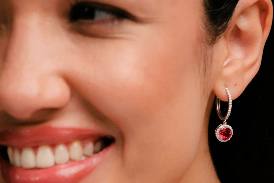 lady wearing ruby diamond halo drop earrings