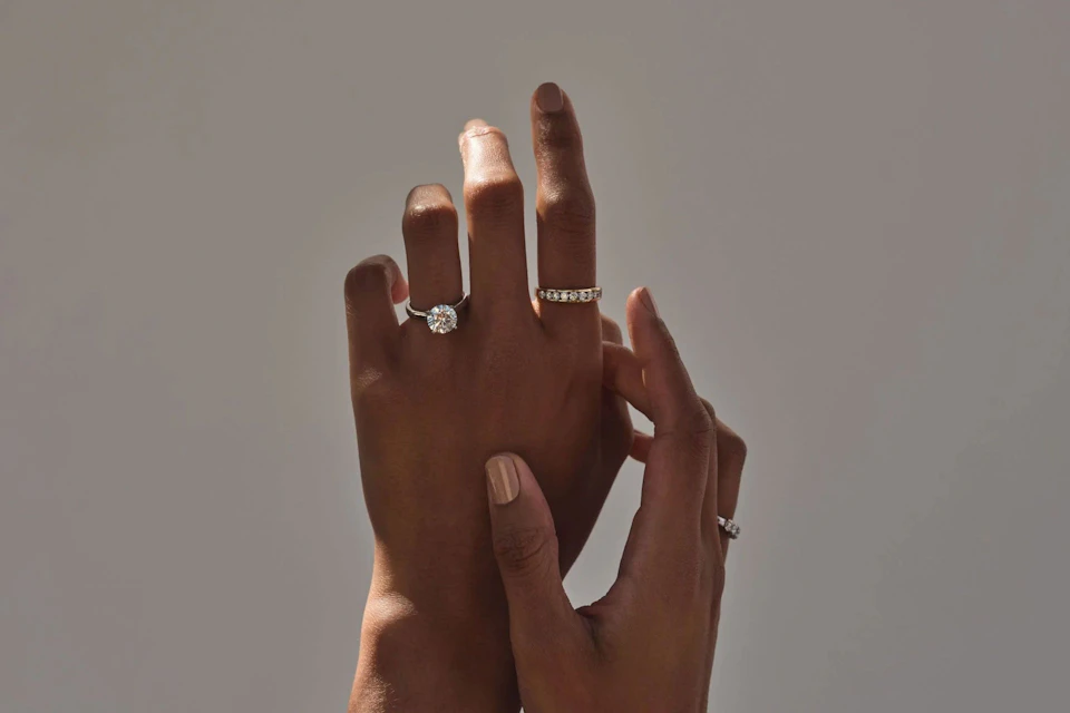 raising hands wearing jewellery