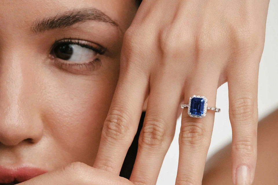 woman with gemstone and diamonds ring