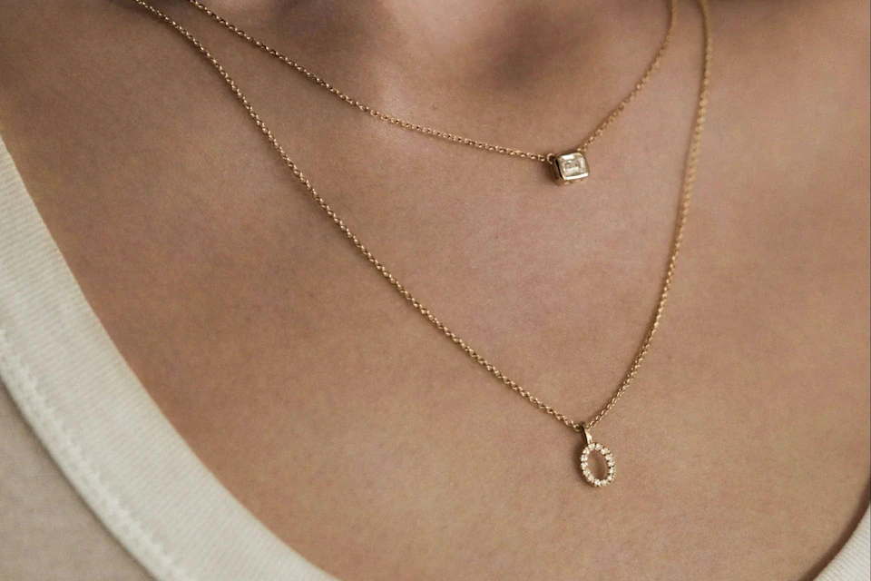 woman wearing layered necklaces