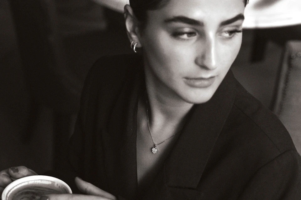 woman in caffe wearing diamond jewellery