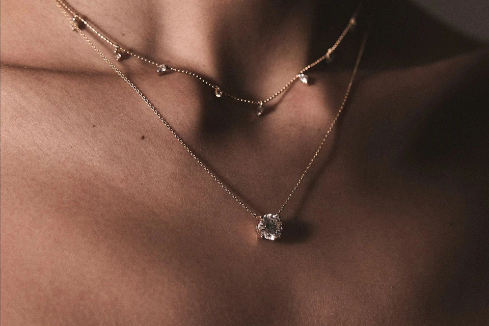 woman wearing stacked necklaces