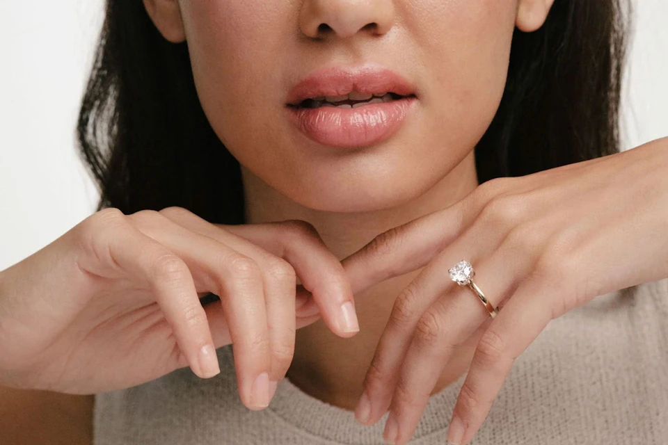 woman wearing solitaire ring