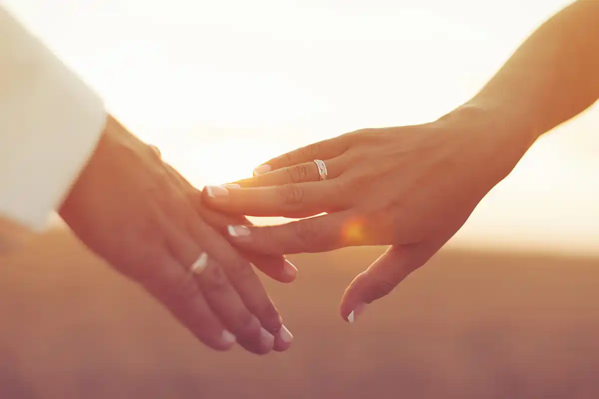 bride and groom hands with engagement rings