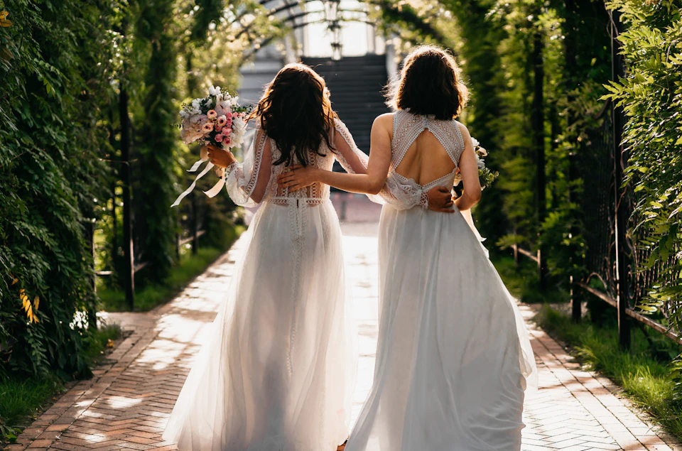 Two brides walking down the aisle