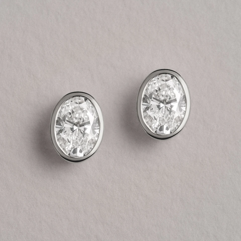 Bezel Set 2.00ct Oval Cut Lab Diamond Stud Earrings in 18K White Gold
