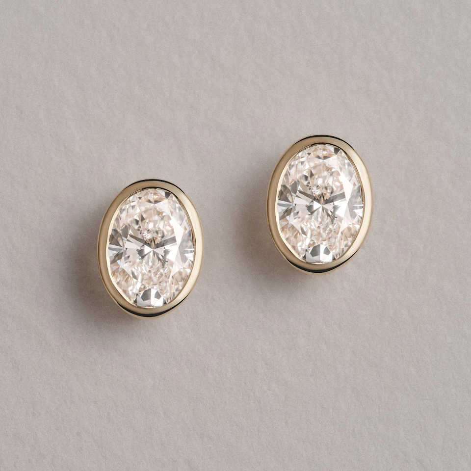 Bezel Set 2.00ct Oval Cut Lab Diamond Stud Earrings in 18K Yellow Gold