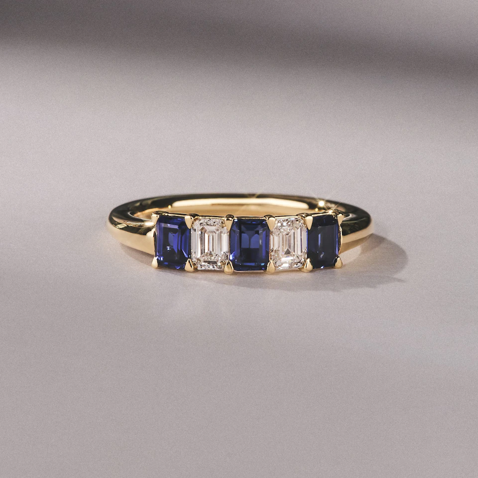 Solene 0.75ct Emerald Cut Lab Sapphire and Lab Diamond Half Band Eternity Ring in 18K Yellow Gold