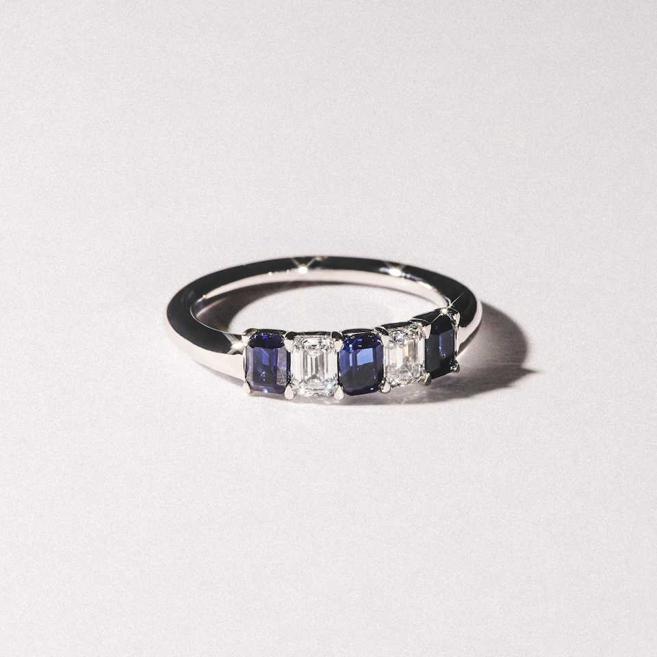 Solene 0.75ct Emerald Cut Lab Sapphire and Lab Diamond Half Band Eternity Ring in 18K White Gold