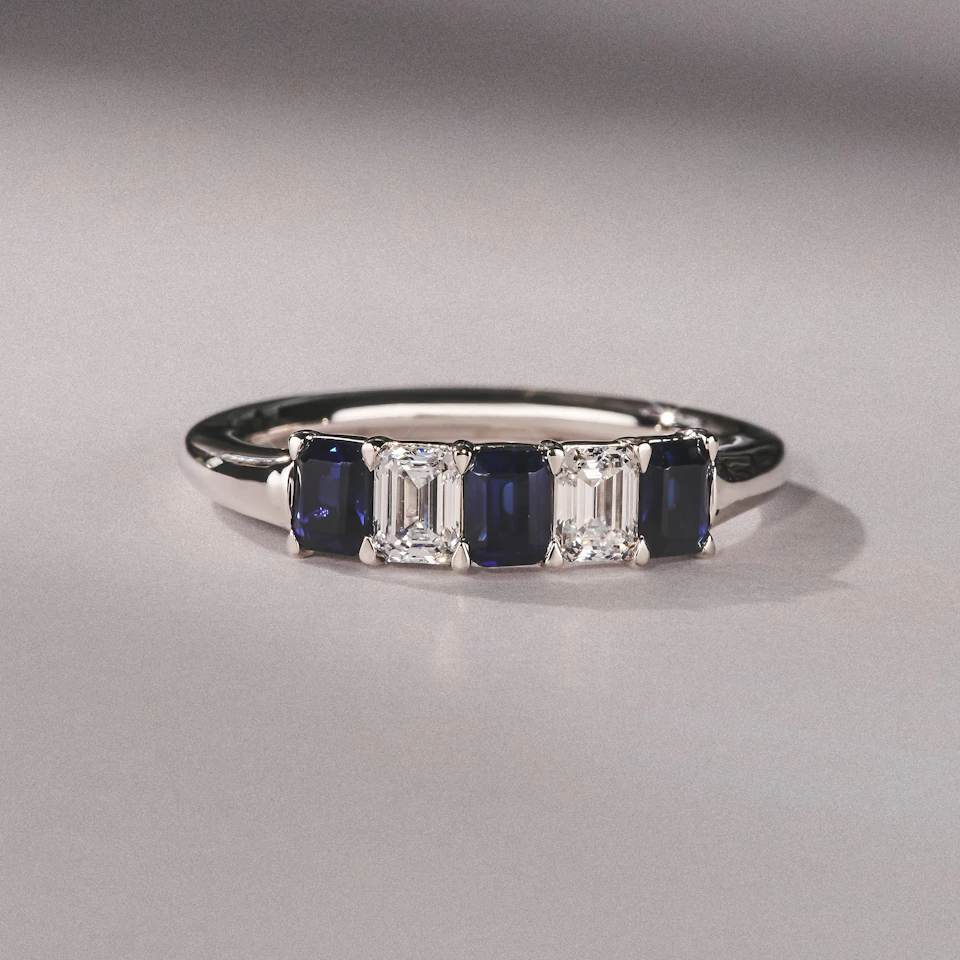 Solene 0.75ct Emerald Cut Lab Sapphire and Lab Diamond Half Band Eternity Ring in 18K White Gold
