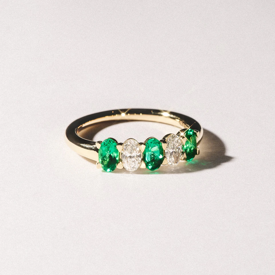 Solene 0.75ct Oval Cut Lab Emerald and Lab Diamond Half Band Eternity Ring in 18K Yellow Gold