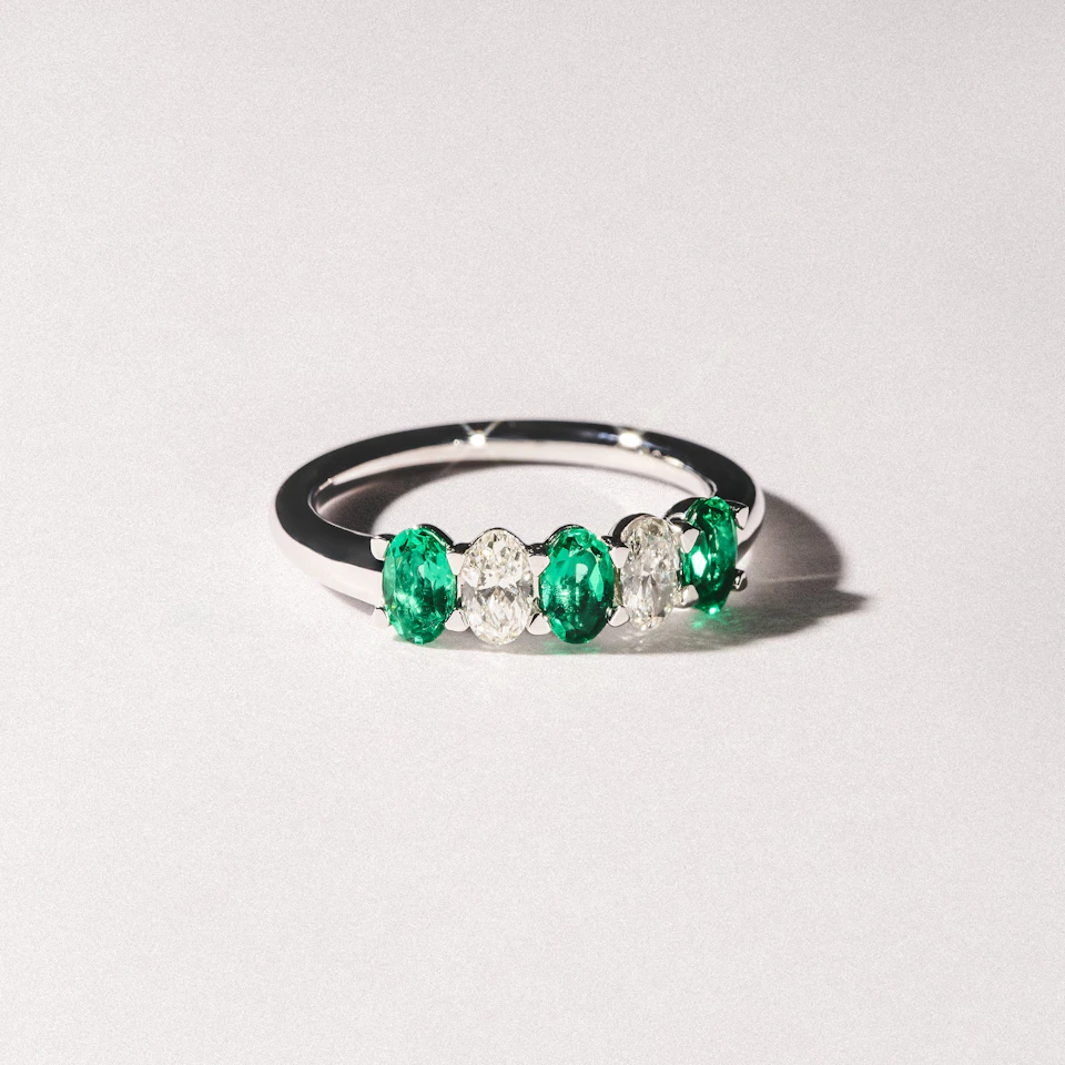 Solene 0.75ct Oval Cut Lab Emerald and Lab Diamond Half Band Eternity Ring in 18K White Gold