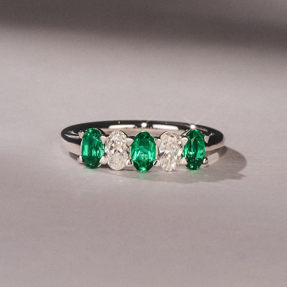Solene 0.75ct Oval Cut Lab Emerald and Lab Diamond Half Band Eternity Ring in 18K White Gold