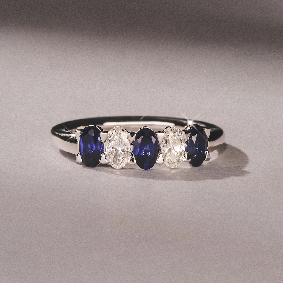 Solene 0.75ct Oval Cut Lab Sapphire and Lab Diamond Half Band Eternity Ring in 18k White Gold