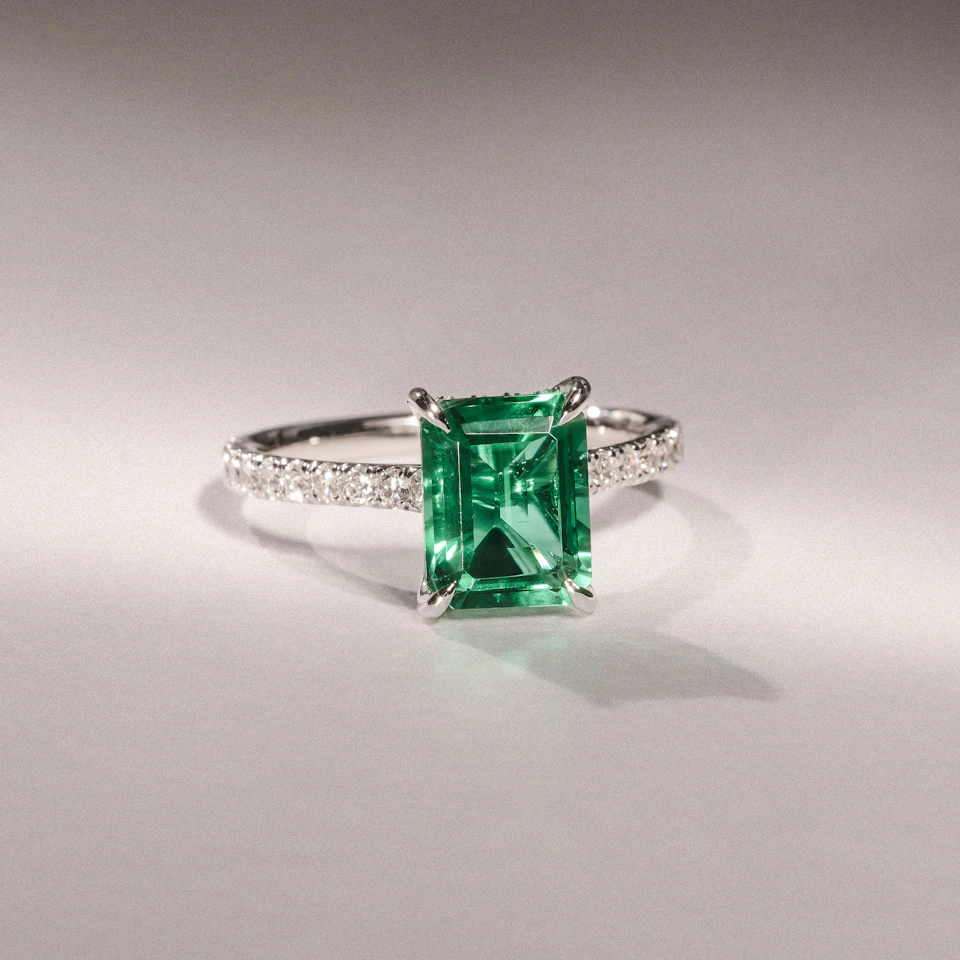 Amora Gem 2.50ct Emerald Cut Lab Emerald Hidden Halo Engagement Ring with Side Stones in 18K White Gold