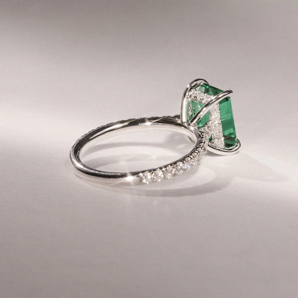 Amora Gem 2.50ct Emerald Cut Lab Emerald Hidden Halo Engagement Ring with Side Stones in 18K White Gold