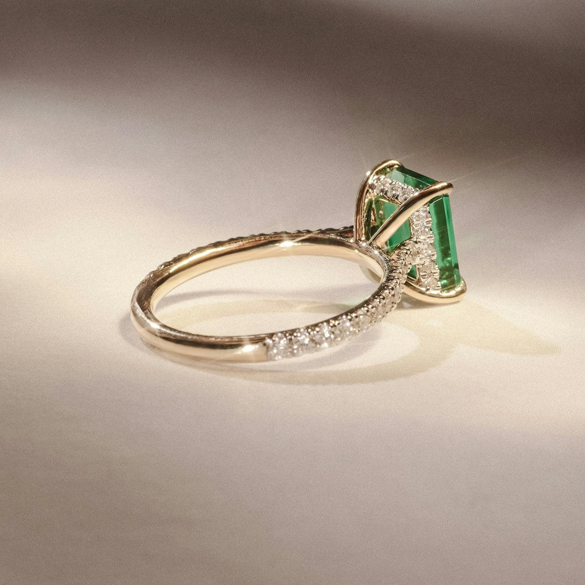 Amora Gem 2.00ct Emerald Cut Lab Emerald Hidden Halo Engagement Ring with Side Stones in 18K Yellow Gold