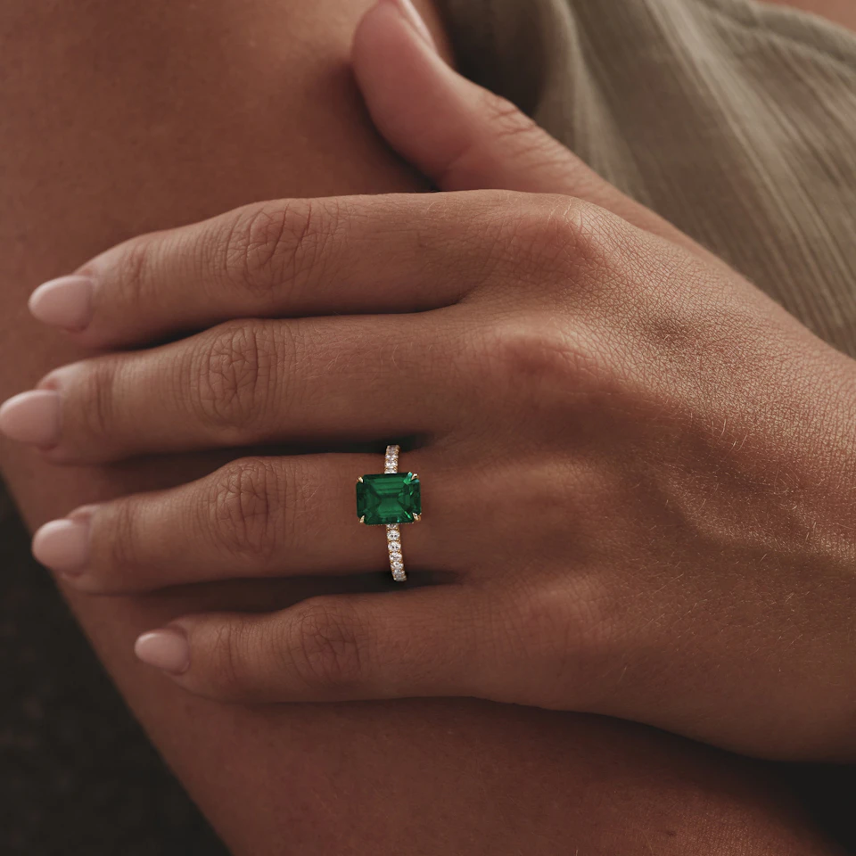 Amora Gem 2.00ct Emerald Cut Lab Emerald Hidden Halo Engagement Ring with Side Stones in 18K Yellow Gold